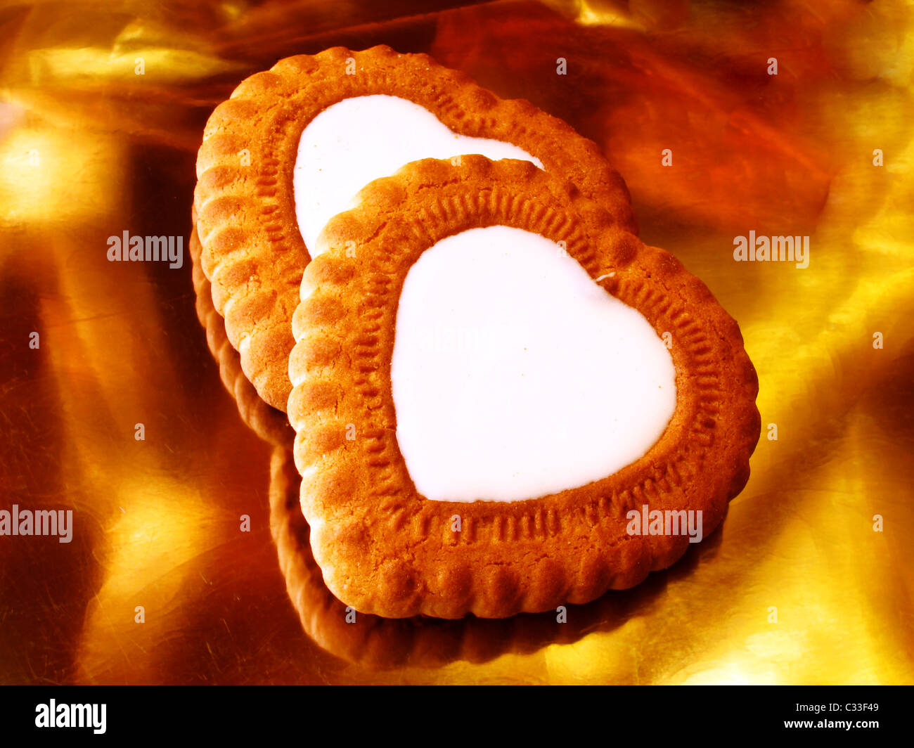 heart-like biscuits over golden background Stock Photo