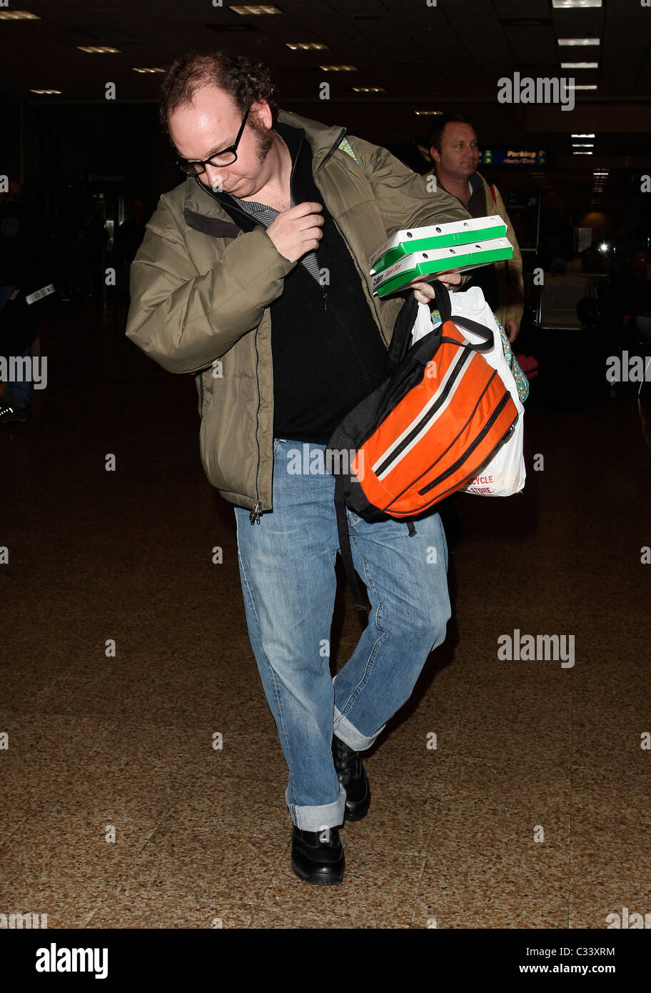 Cold Souls' star Paul Giamatti, carrying luggage and food from Sbarro, arrives at Salt Lake City airport with his son for the Stock Photo