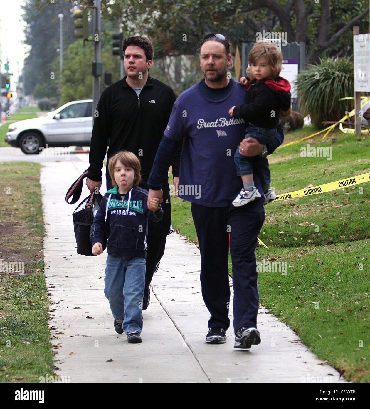 Russell Crowe's son Charlie sticks his tongue out at photographers as ...