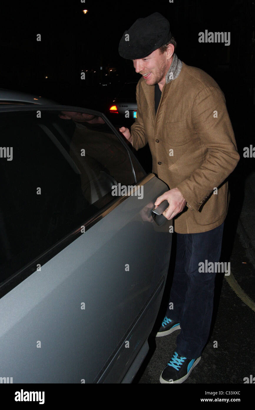 Guy Ritchie appears to be happy although he has some trouble getting in his ride home after