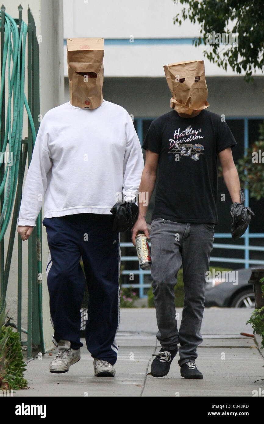 Shia LaBeouf tries to hide his identity by wearing a paper bag mask and  plastic bag over his wrist cast as he takes a stroll Stock Photo - Alamy