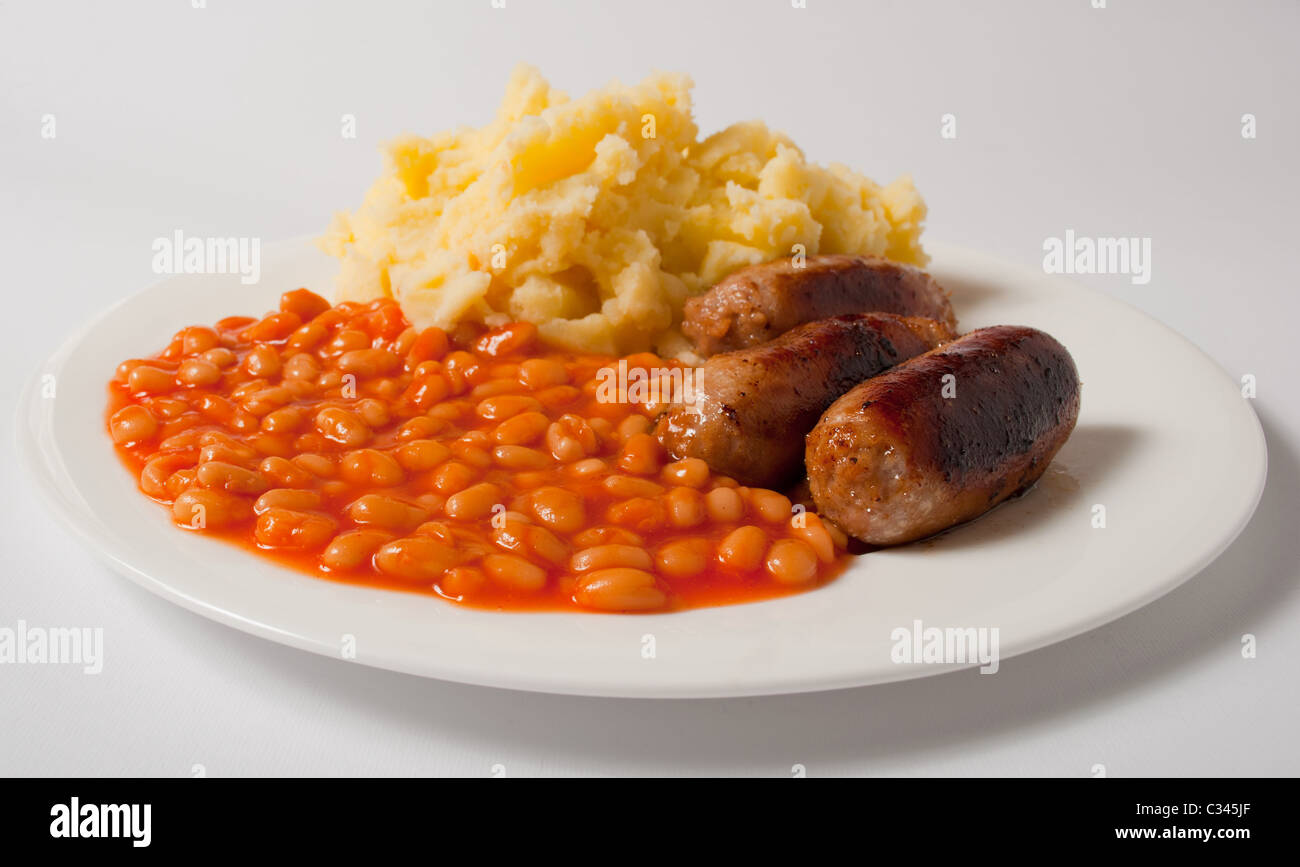 Sausages mashed potato and baked beans on a white plate Stock Photo