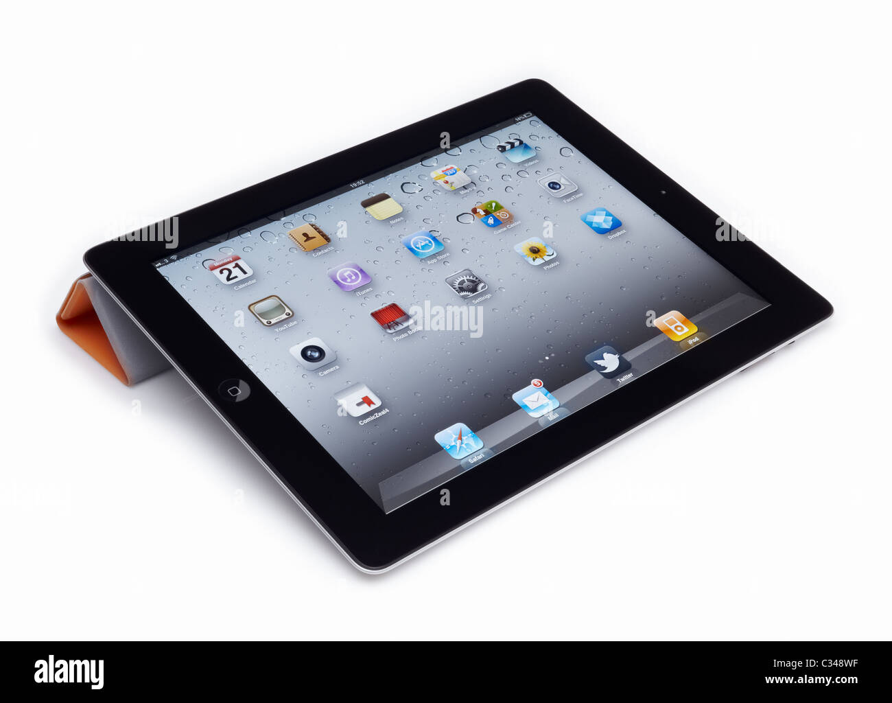 Apple iPad 2 with Smart Cover cut out on a white background with reflection and clipping path. Stock Photo