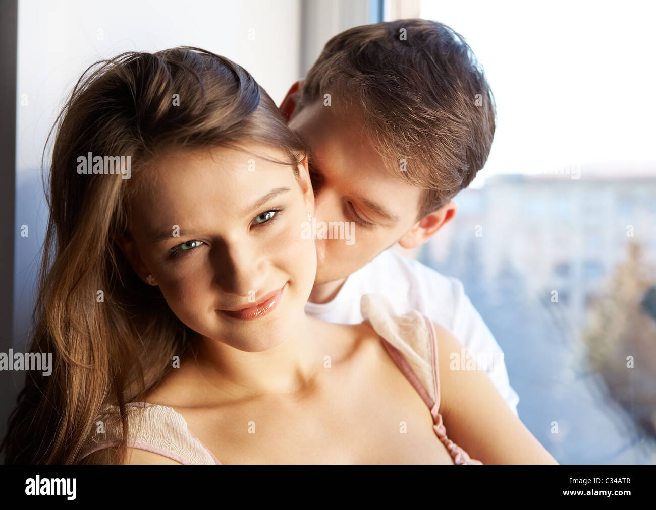 Close-up of young man kissing in woman's neck Stock Photo - Alamy