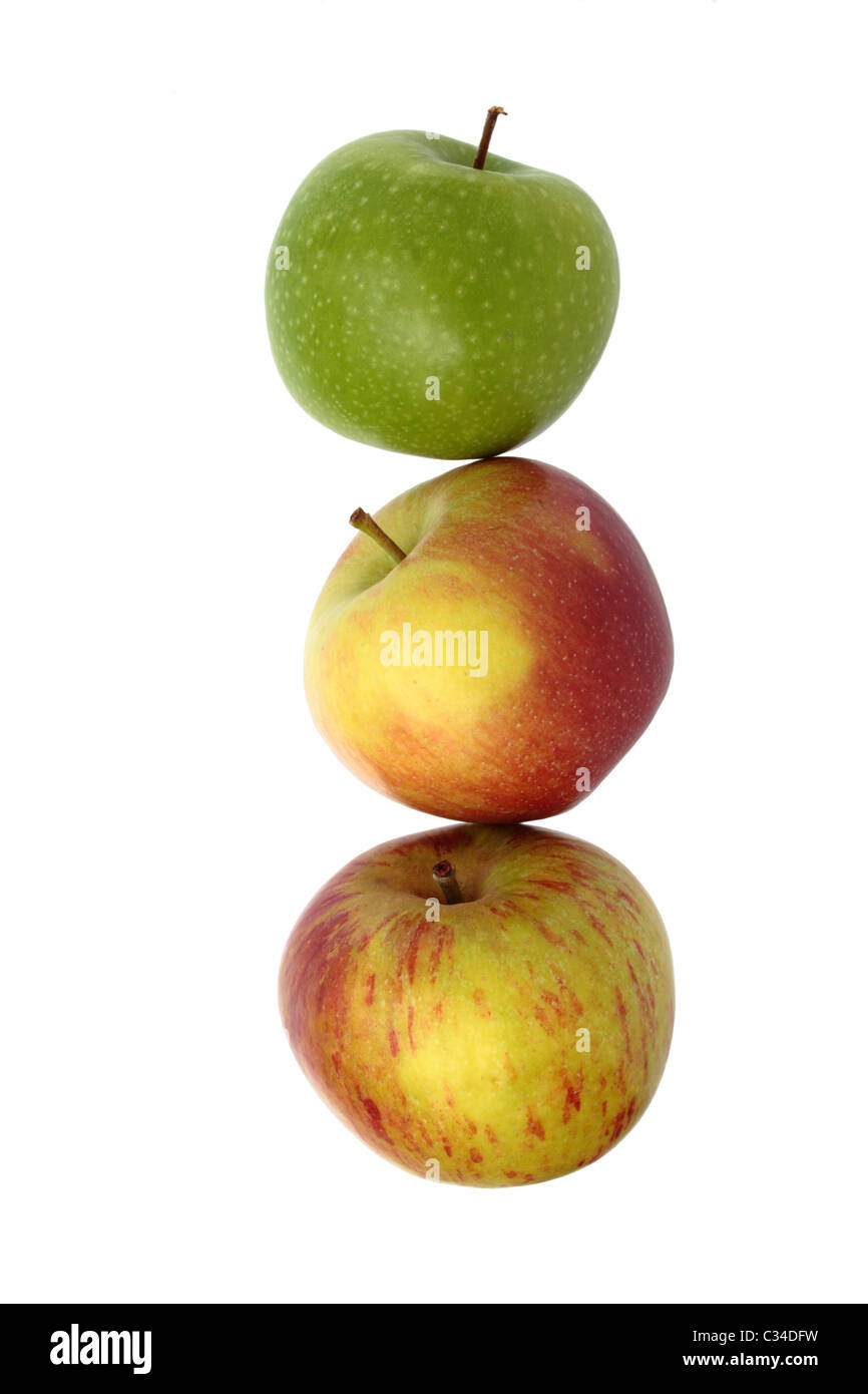 Three apples, appear as if stacked, isolated on a white background. Granny Smith, Braeburn and Cox varieties. Stock Photo