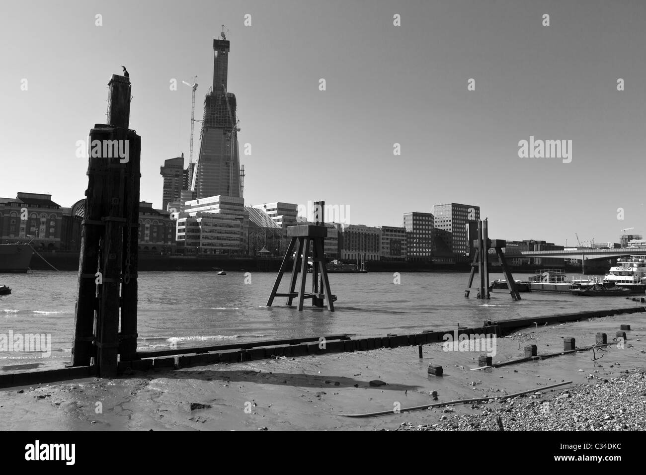 The Shard of Glass skyscraper under construction. Taken from the river Thames at low tide, London, UK. Stock Photo