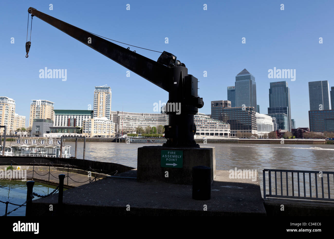 Old crane with Canary Wharf in the background, London, England, UK