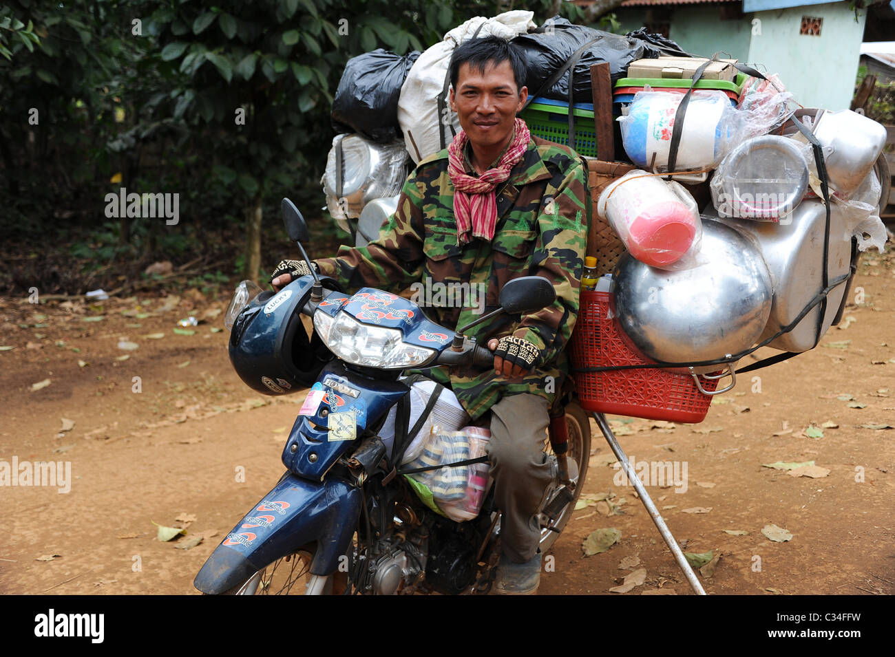 Vendor on motorbike selling his wares in Dakdam village near Sen