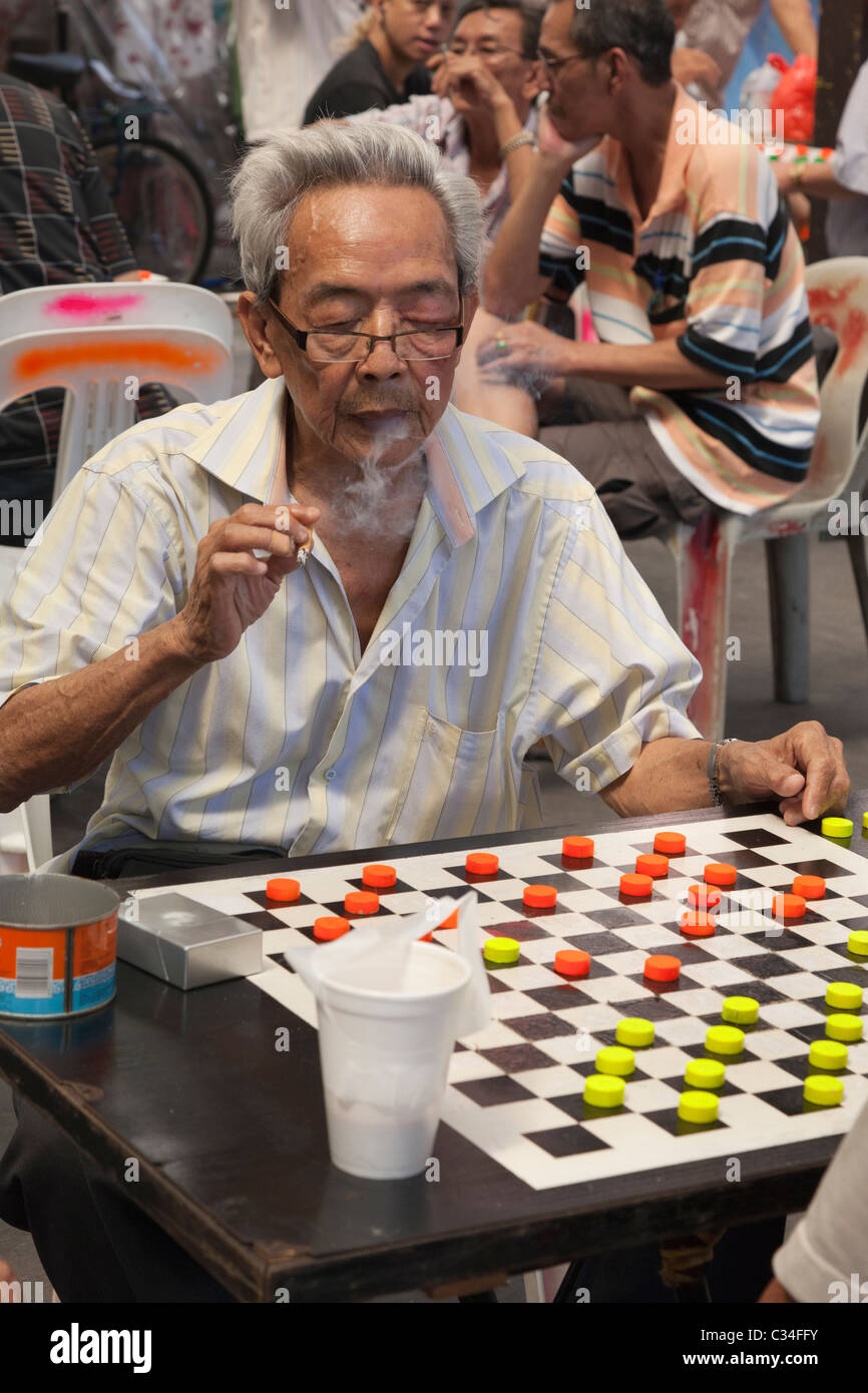 Chinatown, Singapore - smoking man playing checkers 2 Stock Photo