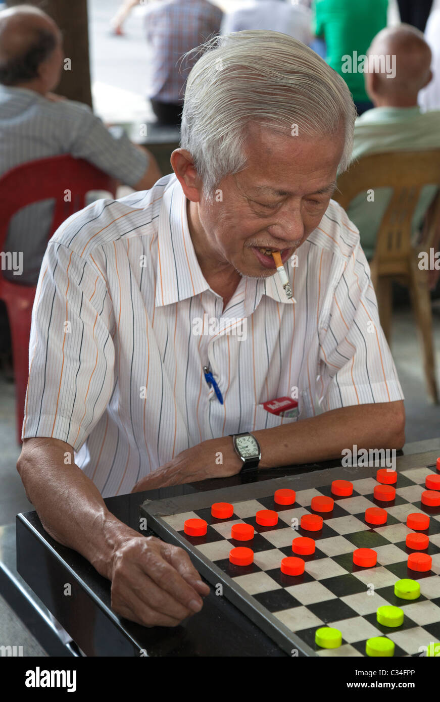 Chinatown, Singapore - smoking man playing checkers 6 Stock Photo