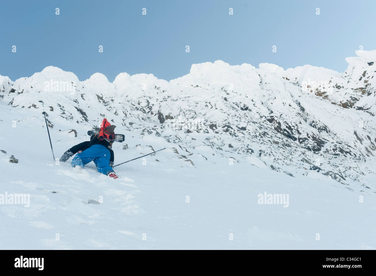 A free skier climbing up a snowy mountain side at Lofoten Islands, Norway Stock Photo
