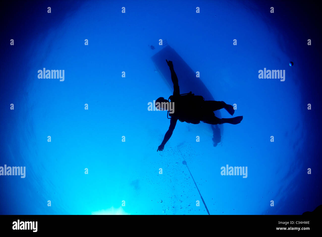 A Scuba diver descends into the blue. Stock Photo