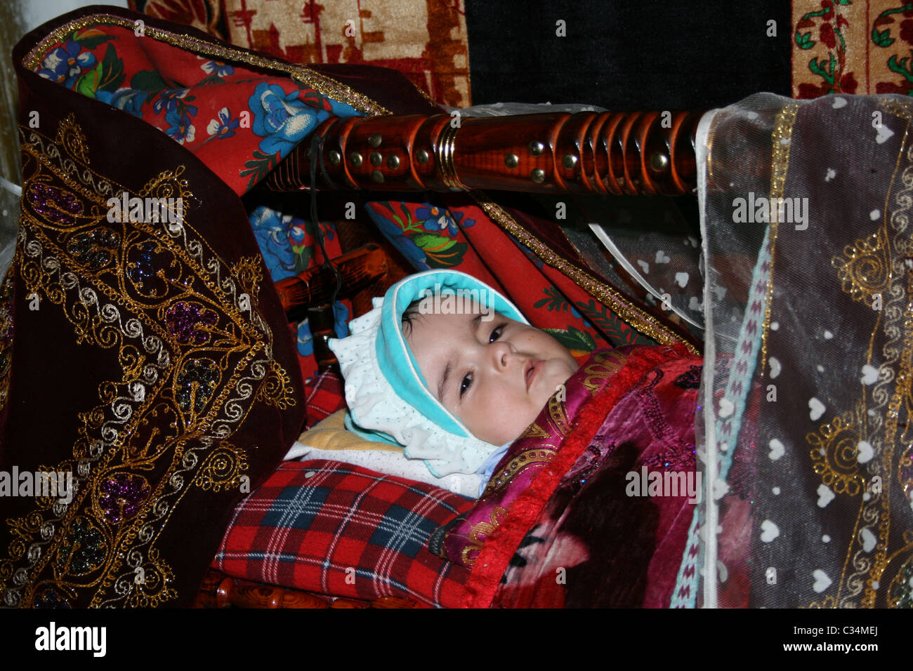 Little boy in traditional Tajik cradle, nzob village, Tajikistan Stock Photo