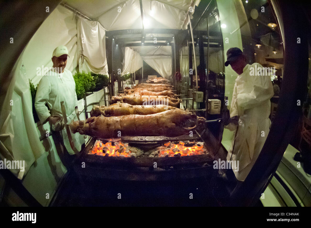 18 lambs are roasted over coals in front of a Greek restaurant in
