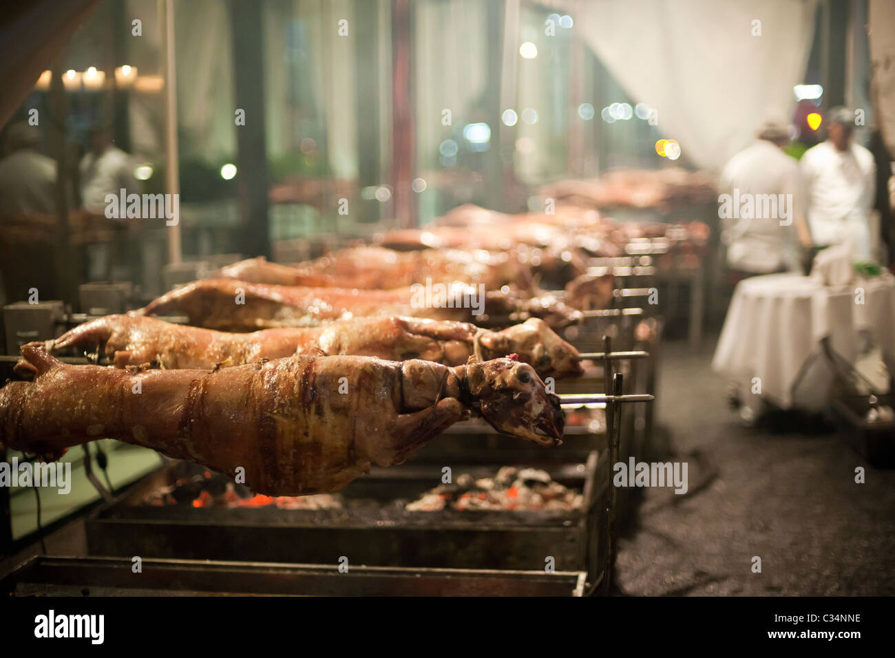 18 lambs are roasted over coals in front of a Greek restaurant in New