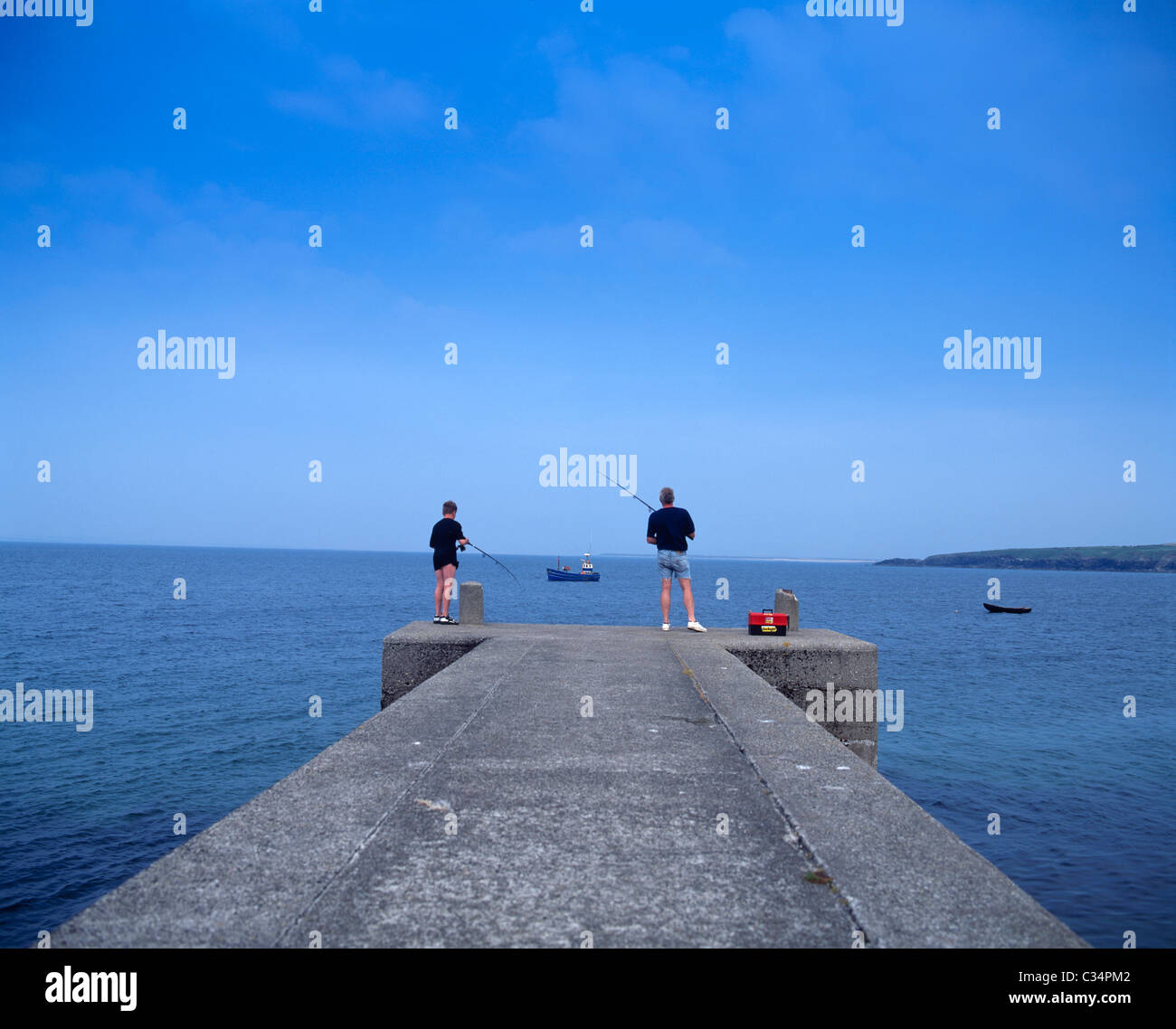 Achill Island,Co Mayo,Ireland;Father And Son Fishing Off Doogort Pier Stock Photo