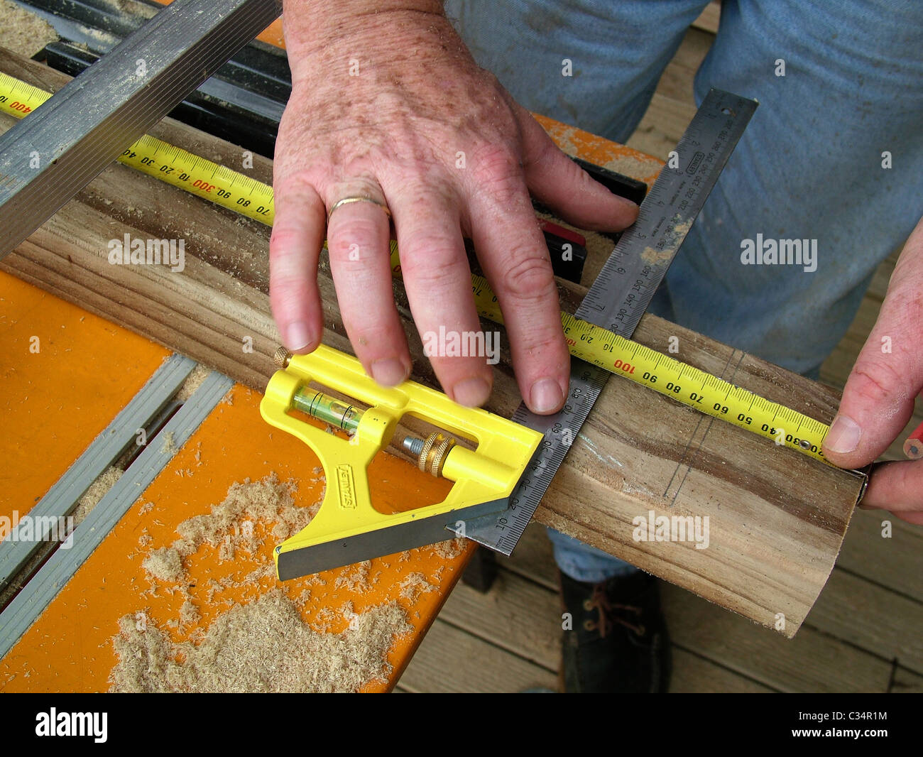 Measuring wood on work bench carpentry work while building a deck