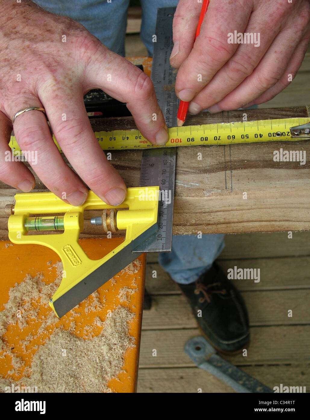 Measuring wood on work bench carpentry work while building a deck
