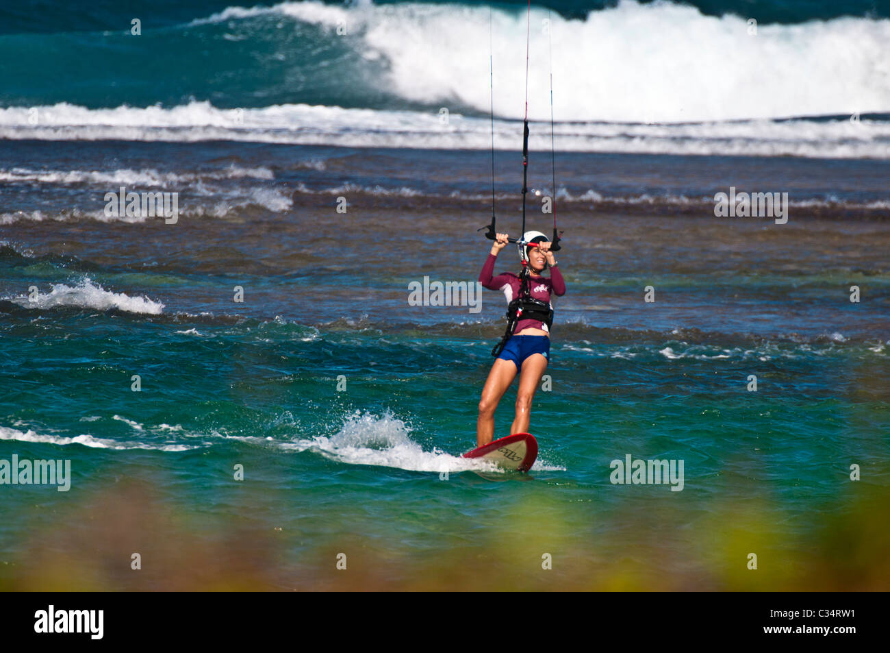 Woman kitesurfing, Kauai, Hawaii Stock Photo