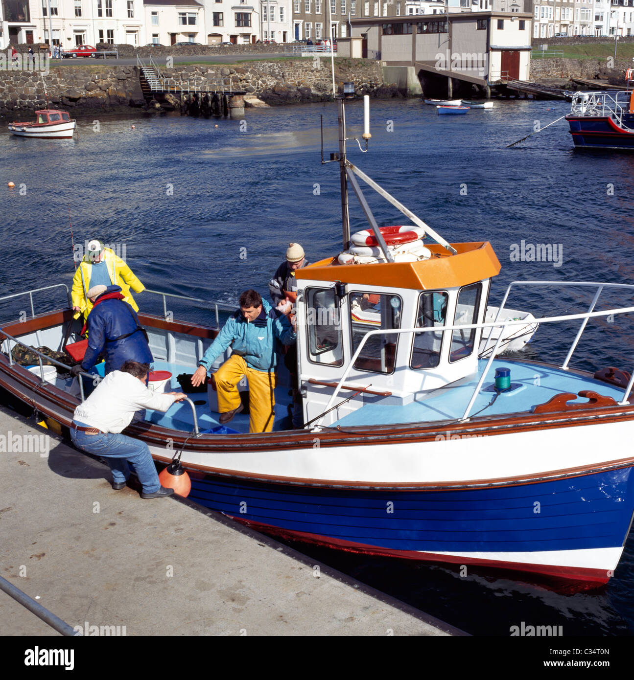 Fishermen On Boat, Portrush Harbour, County Antrim, Northern Ireland Stock Photo