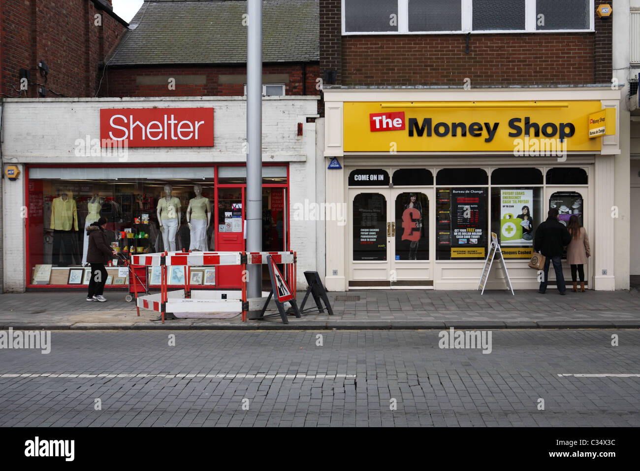 A Shelter charity shop and a pawn broker's or Money Shop in Blyth, north east england, UK Stock Photo