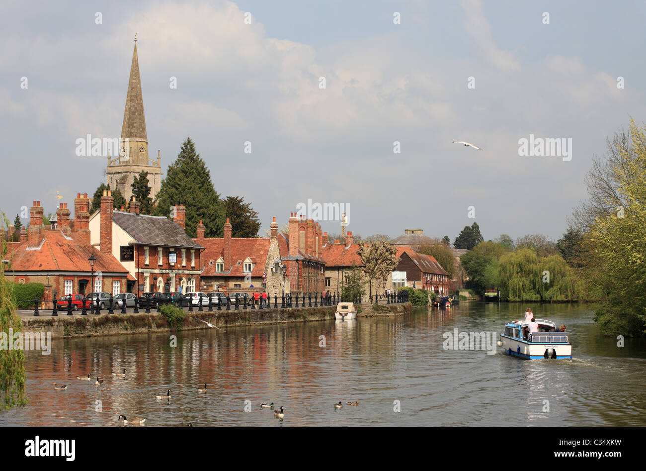 A canal boat passes the Old Anchor Inn on the river Thames, Abingdon