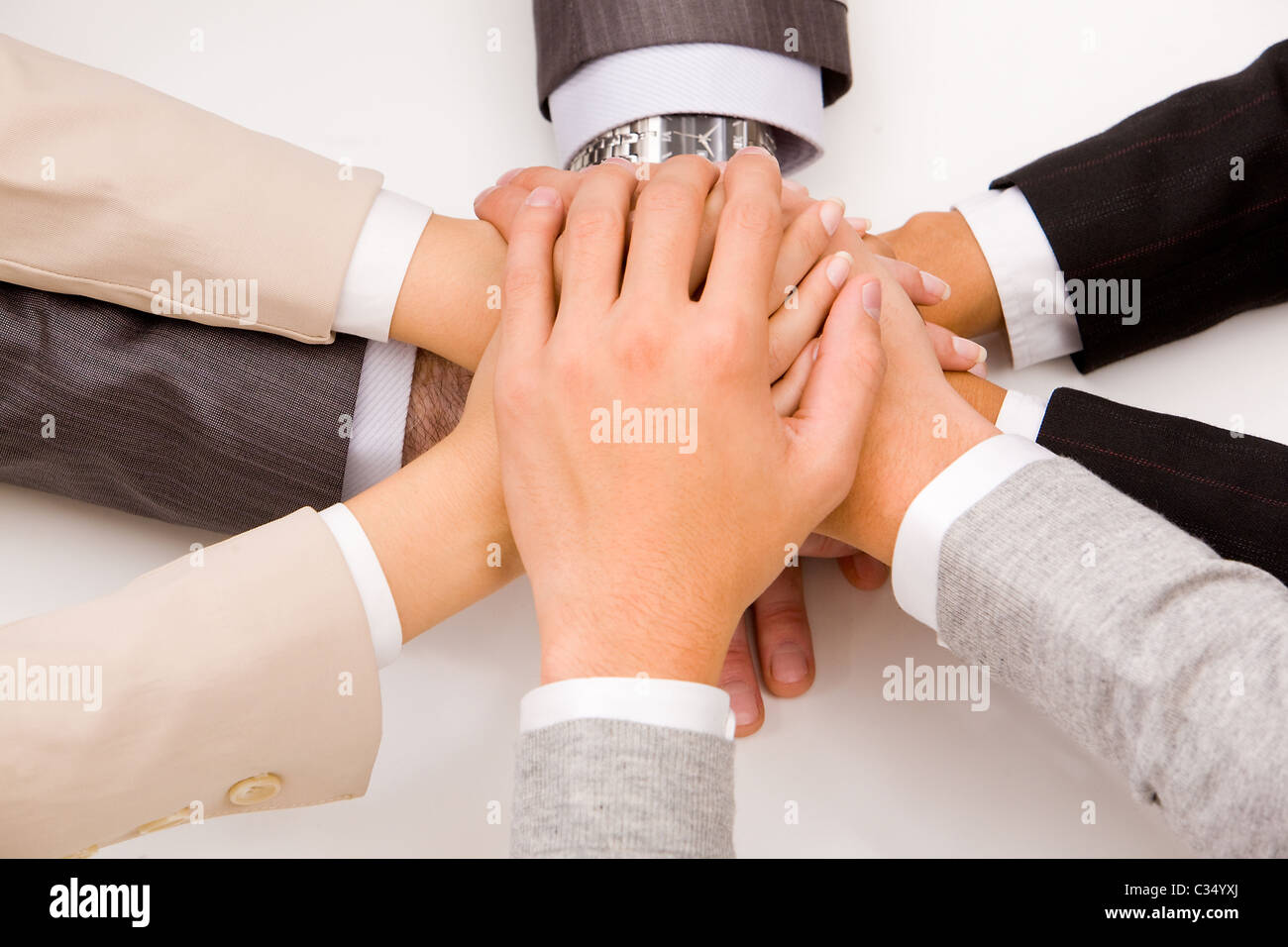 Close-up of business people’s hands on top of each other Stock Photo ...