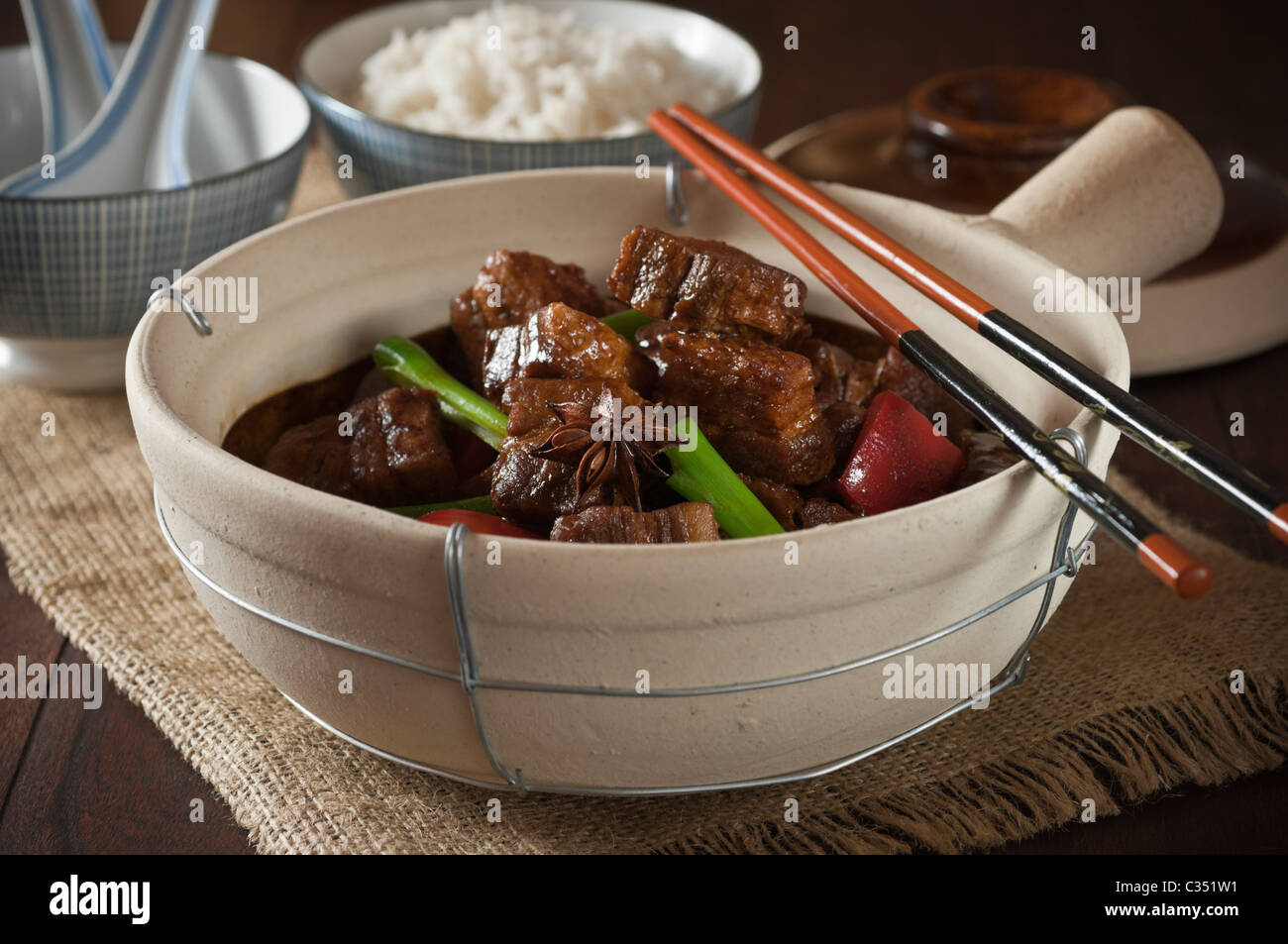 Red cooked pork belly in traditional clay pot. Chinese food Stock Photo