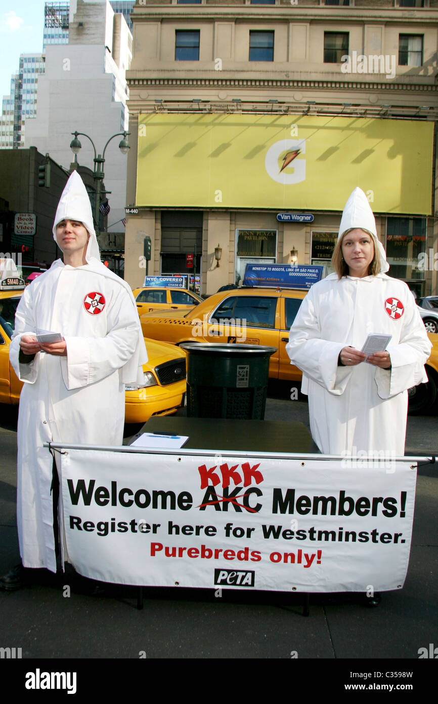 PETA members dressed in Ku Klux Klan white robes and conical hats protest outside the Westminster Kennel Club Dog Show at Stock Photo