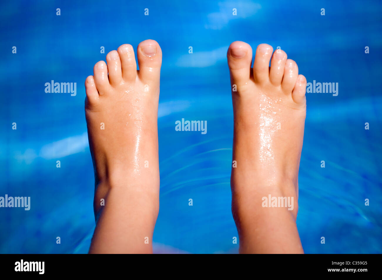 Child's feet in a swimming pool Stock Photo Alamy