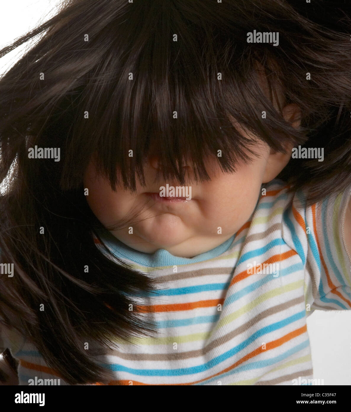 Baby boy wearing wig Stock Photo Alamy