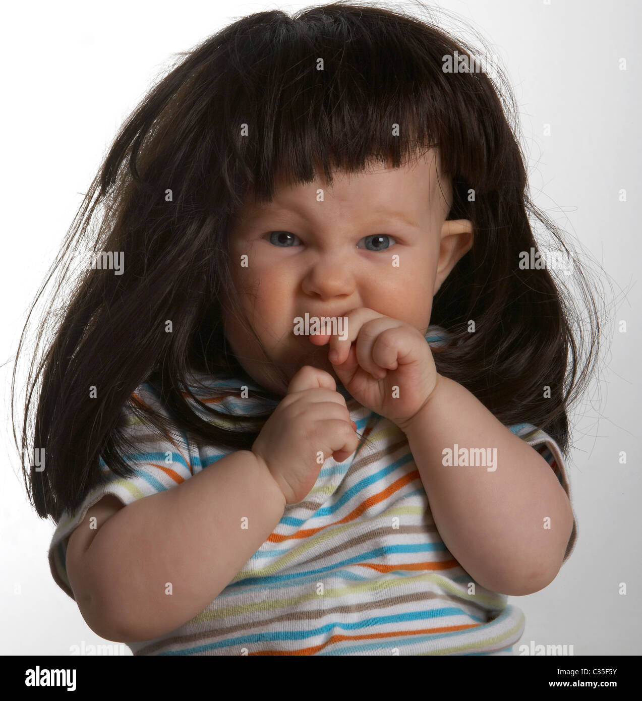 Baby boy wearing wig Stock Photo Alamy