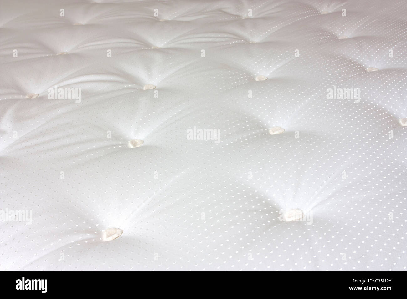 close up of a bed matress with hand tufted detail Stock Photo