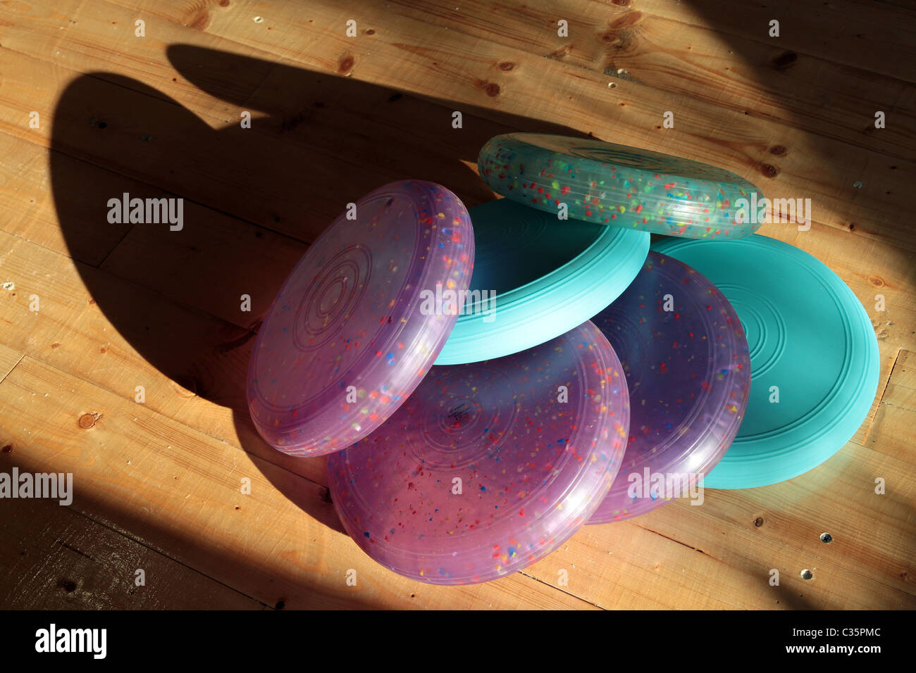 plastic round pillows used for athletics pilates and sports shoot under strong sunlight and shadows Stock Photo