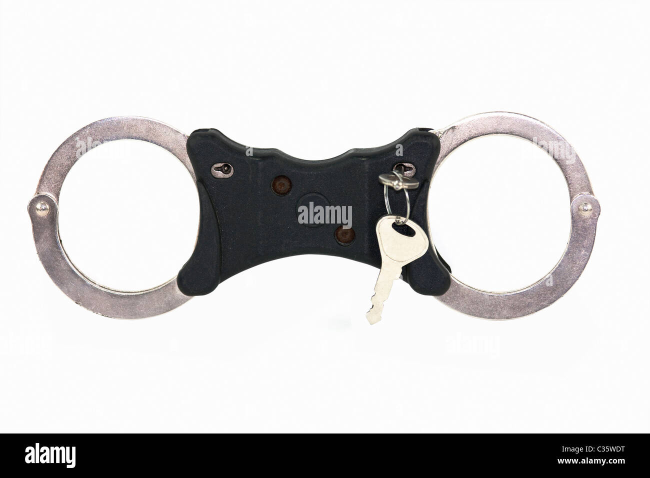 isolated closed handcuffs on white background with key Stock Photo
