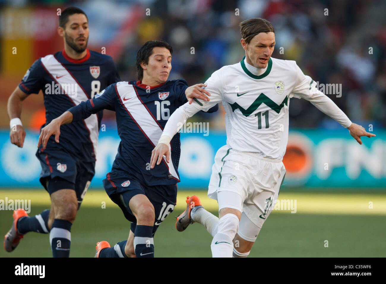 Milivoje Novakovic of Slovenia (11) in action under pressure from Francisco Torres of the USA (16) during a FIFA World Cup match Stock Photo