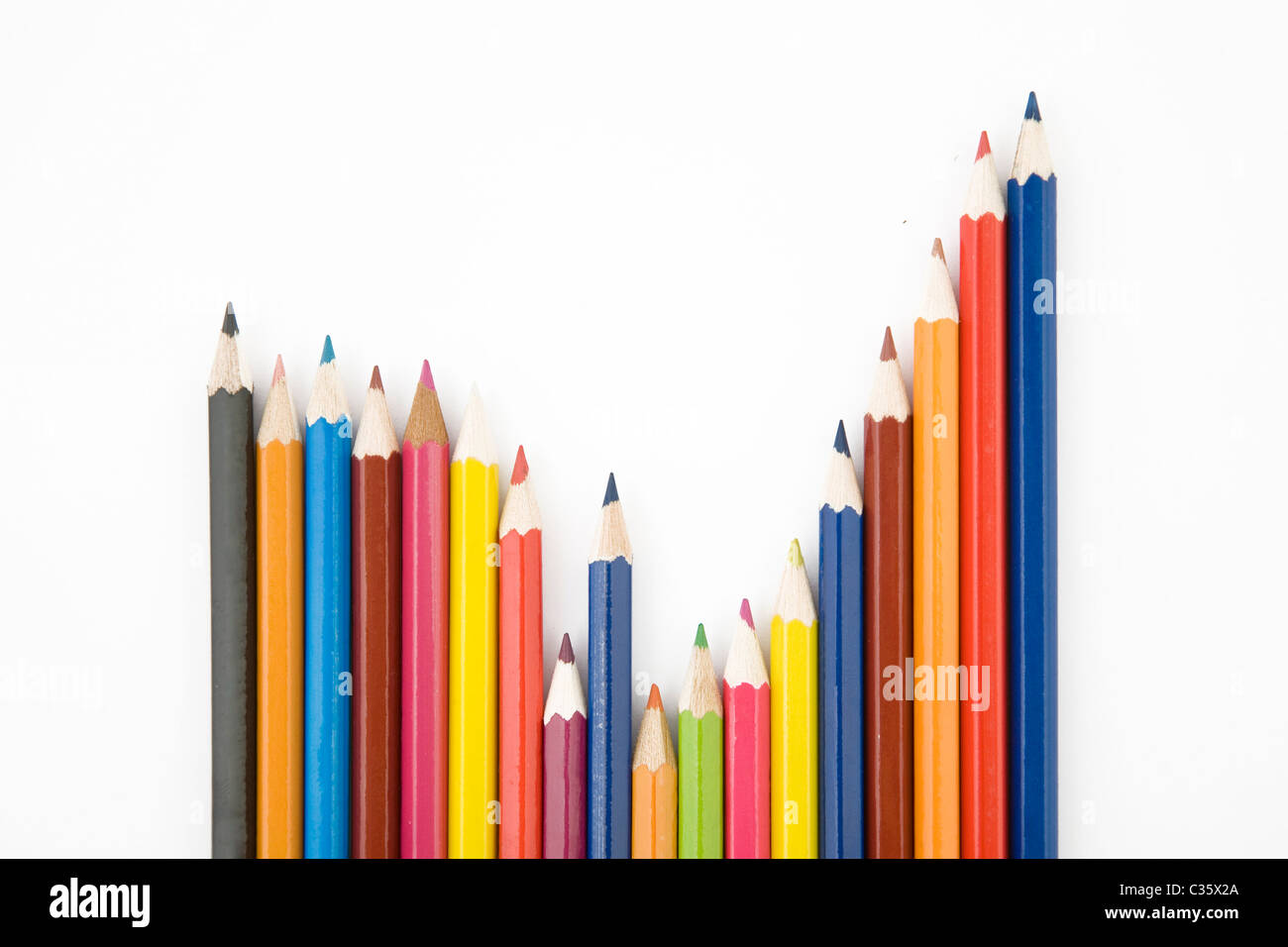 front view of color pencils over white background, arranged in graphic shape Stock Photo