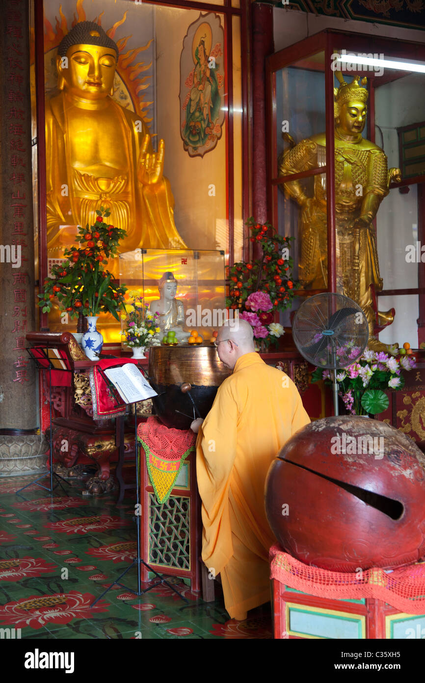 Kek Sok Si Temple, Penang Malaysia- monk beating gong Stock Photo