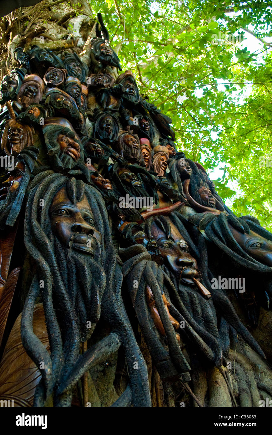 Wood carvings displayed on a tree at Dunn's River Falls, near Ocho Rios, St Ann, Jamaica Stock Photo