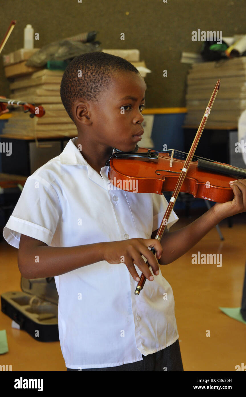 Kids are learning to play the violin in one of the townships around