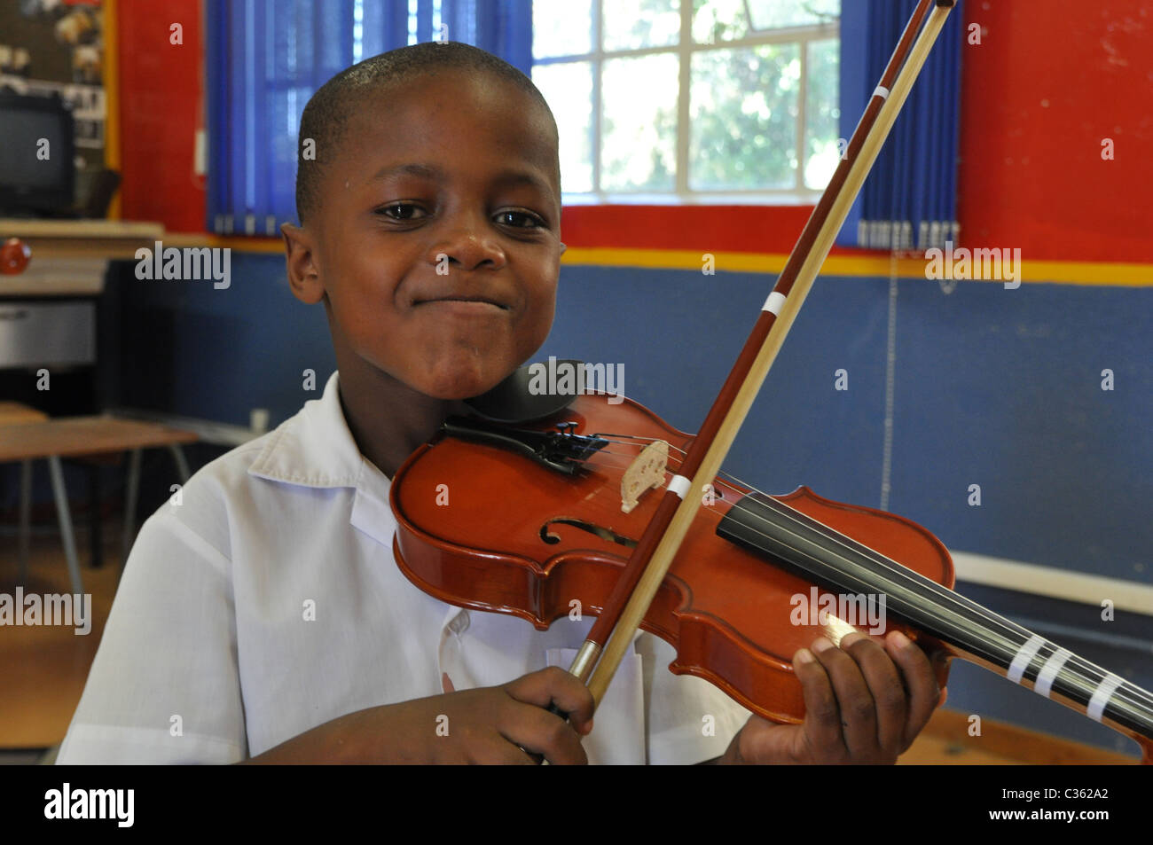 Kids are learning to play the violin in one of the townships around
