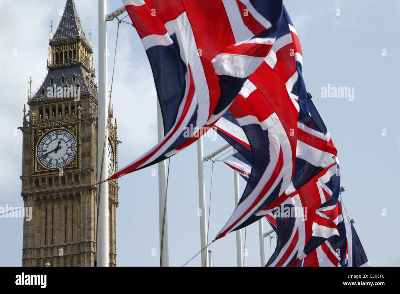 Union Flags flying in front of Big Ben, London, UK Stock Photo