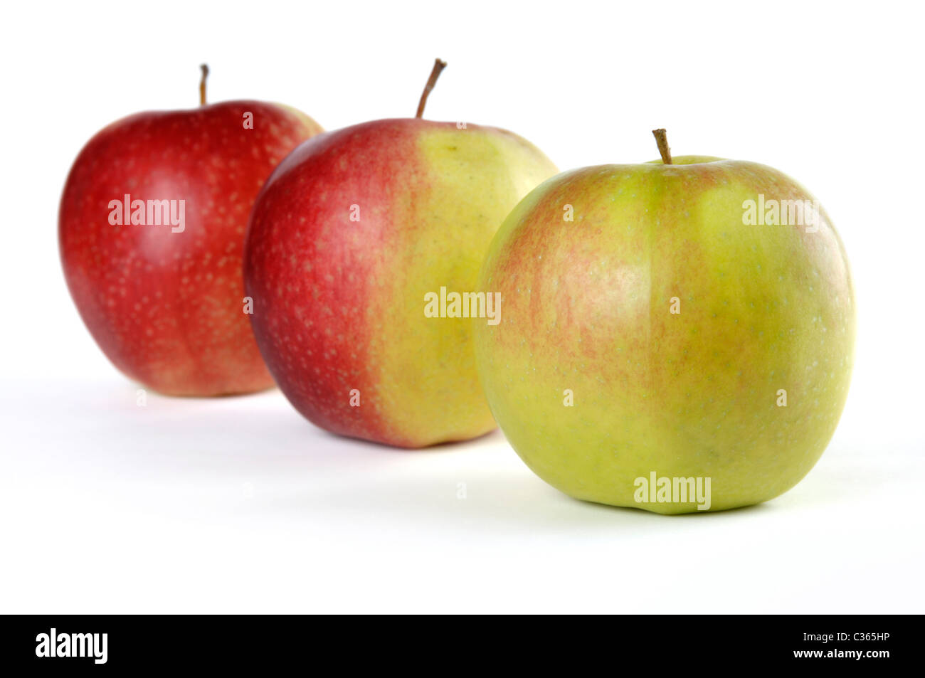 Three apples. Green, half red and red. Isolated on white background