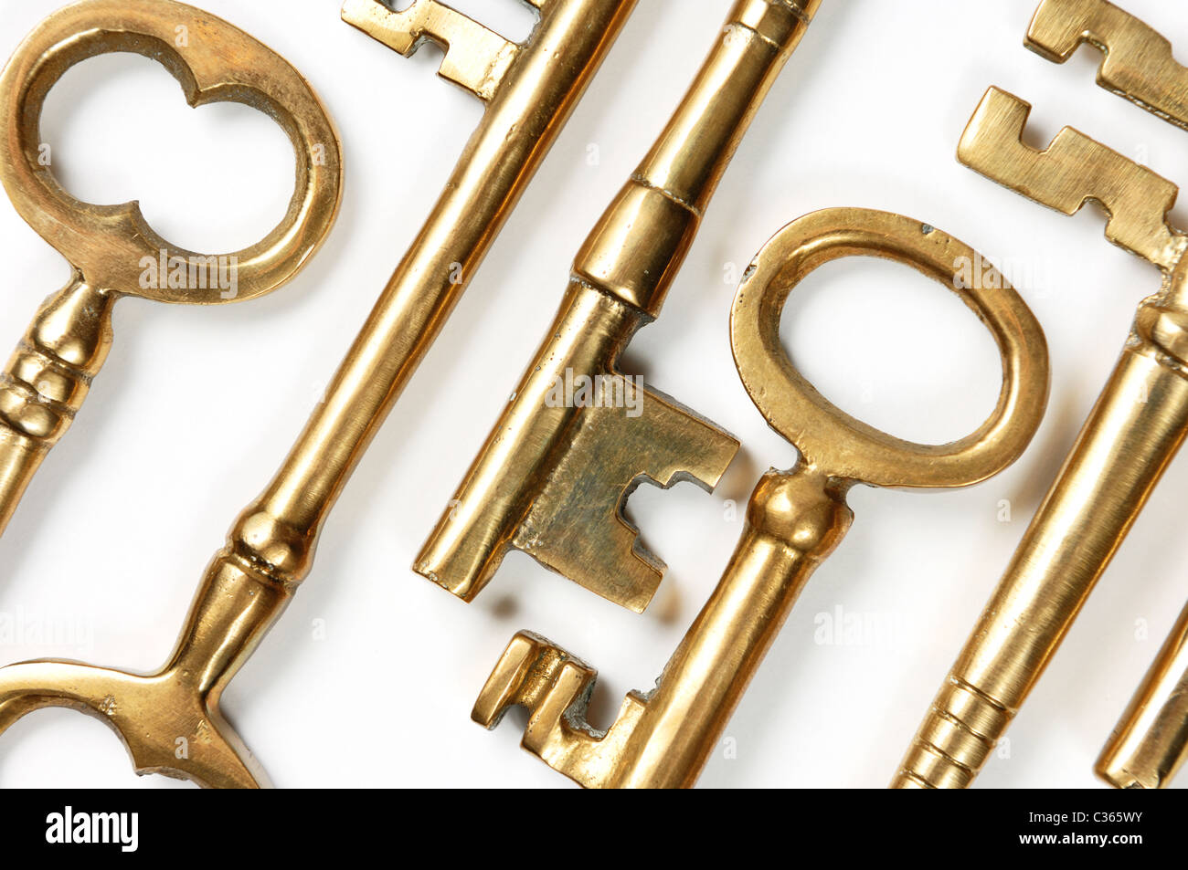 Bunch of old brass keys on white close-up Conceptual abstract