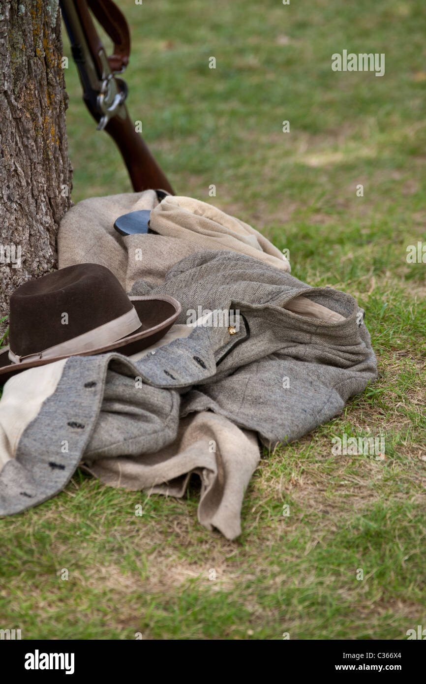 Confederate uniform, pack and rifle lie next to a tree on the Manassas National Battlefield. Also available with less foreground Stock Photo