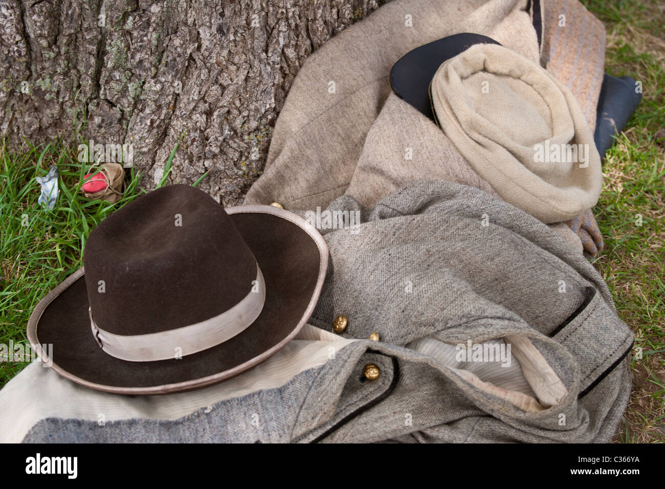 Confederate uniform and pack lie next to a tree on the Manassas National Battlefield. Stock Photo
