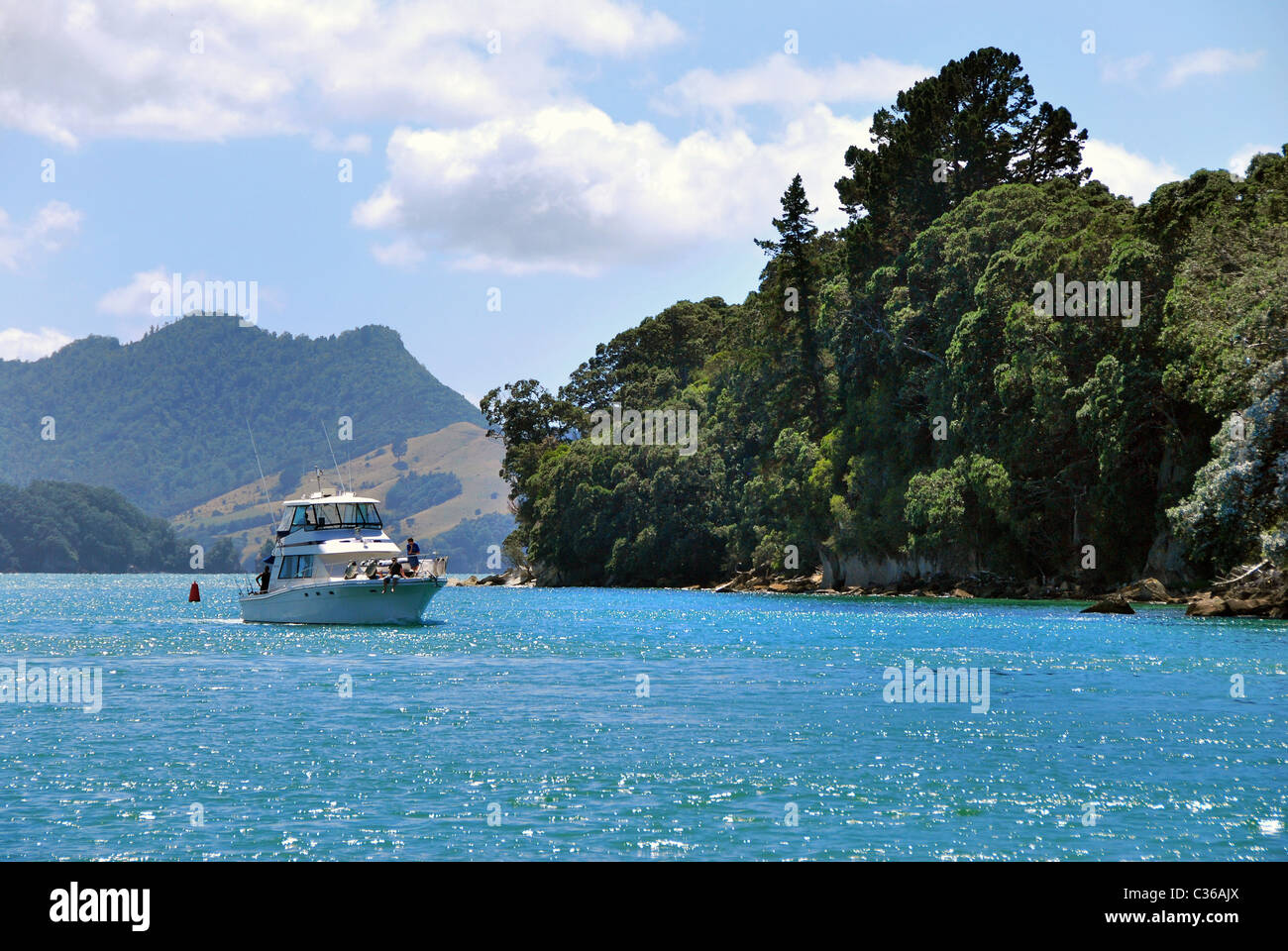 Motor cruiser entering Whitianga Harbour  from Mercury Bay, Coromandel, New Zealand Stock Photo