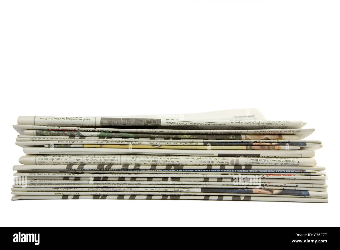 front view of piled up newspapers isolated on a white background Stock Photo