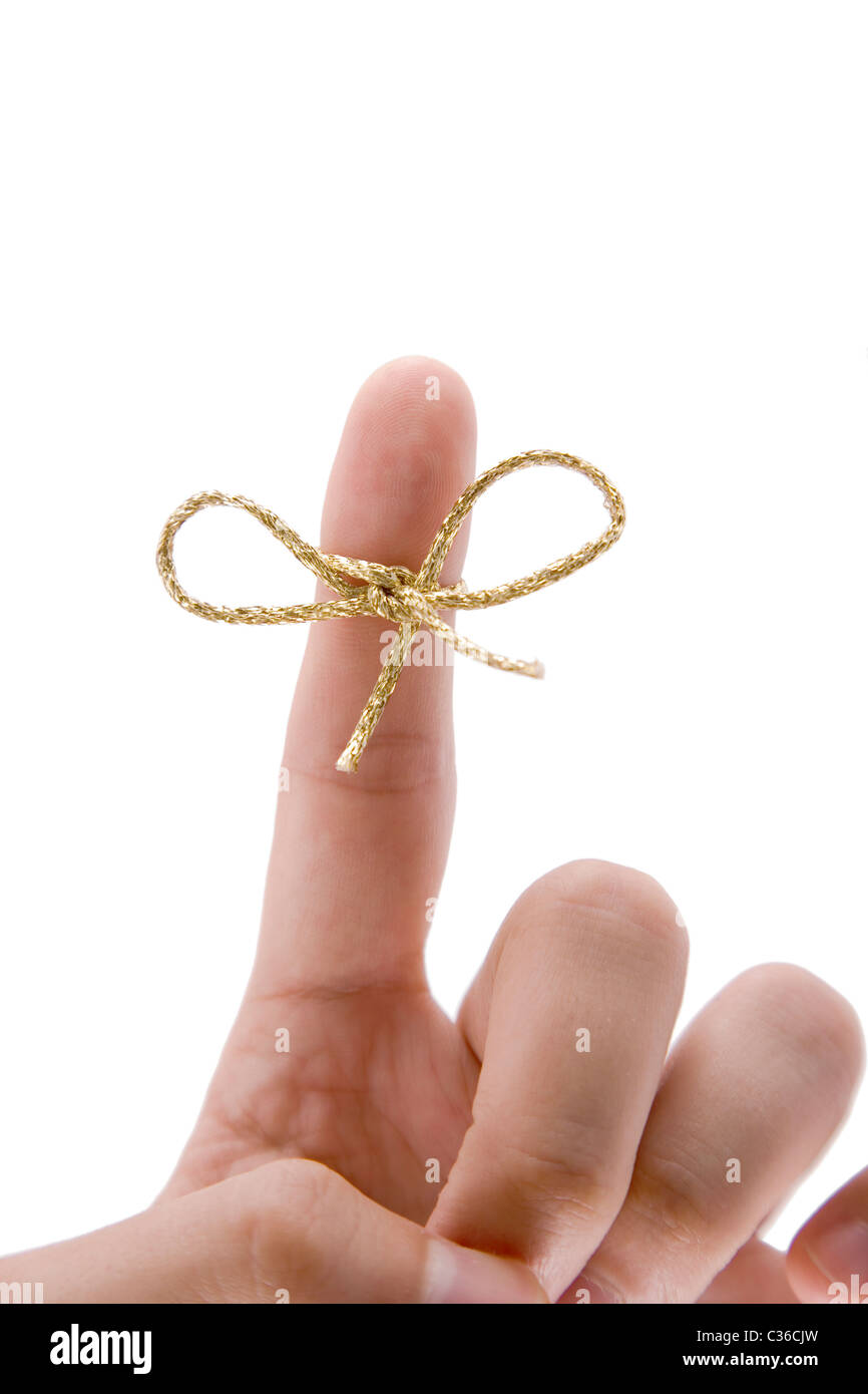 remember concept, finger with gold tie on white background Stock Photo