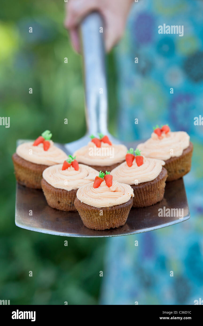 Carrot cupcakes on garden spade selective focus Stock Photo